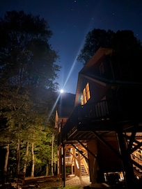 Moon rising over the ridge with the cabin in the foreground.