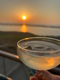Watching the sunset from our balcony with a cocktail