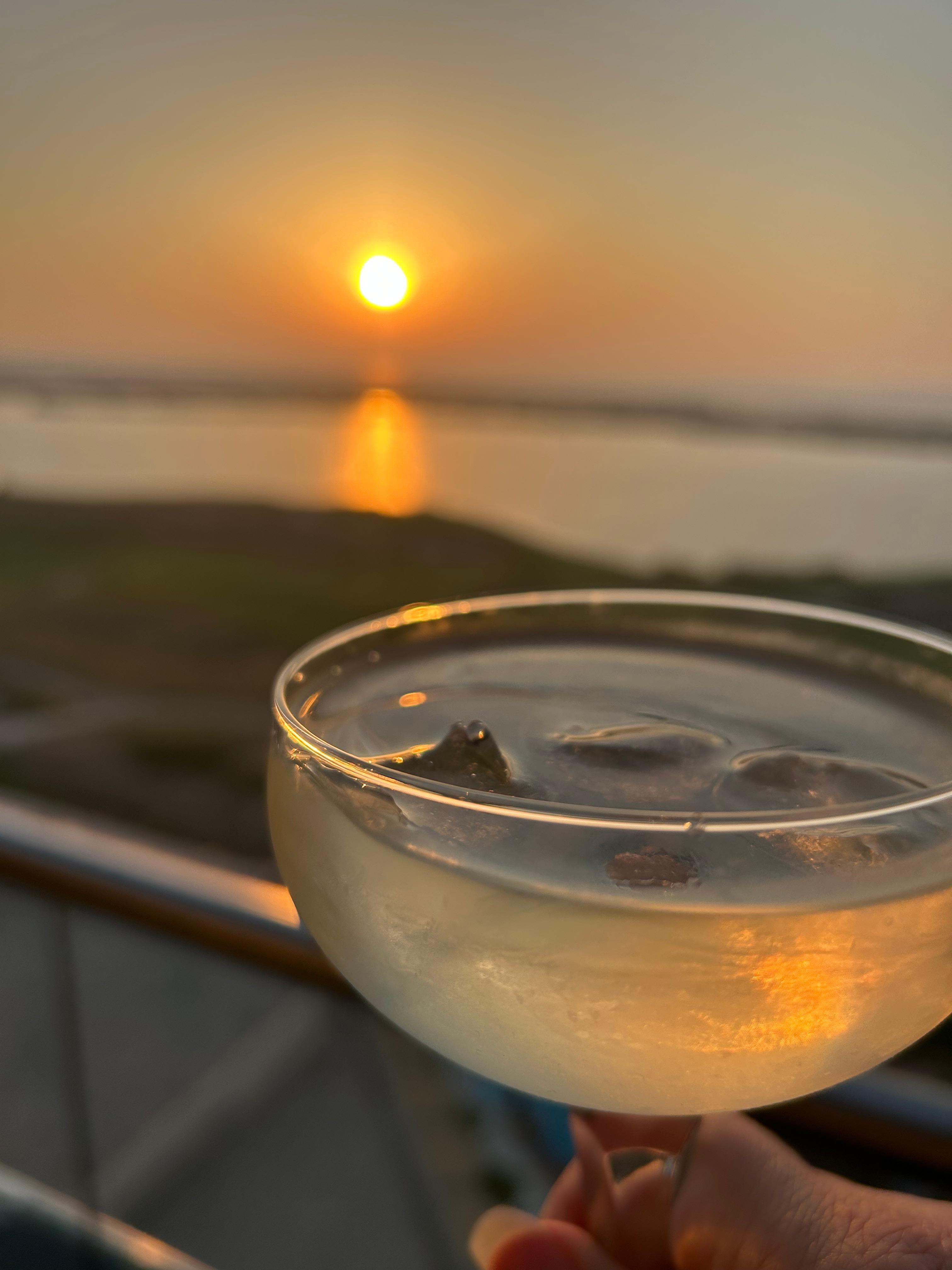 Watching the sunset from our balcony with a cocktail 