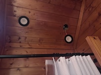 Light hanging over shower in top bathroom to the right