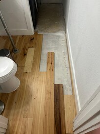 Unfinished florring in half bathroom, not disclosed, owner not aware