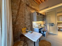 Dining, kitchen area with old walls exposed.