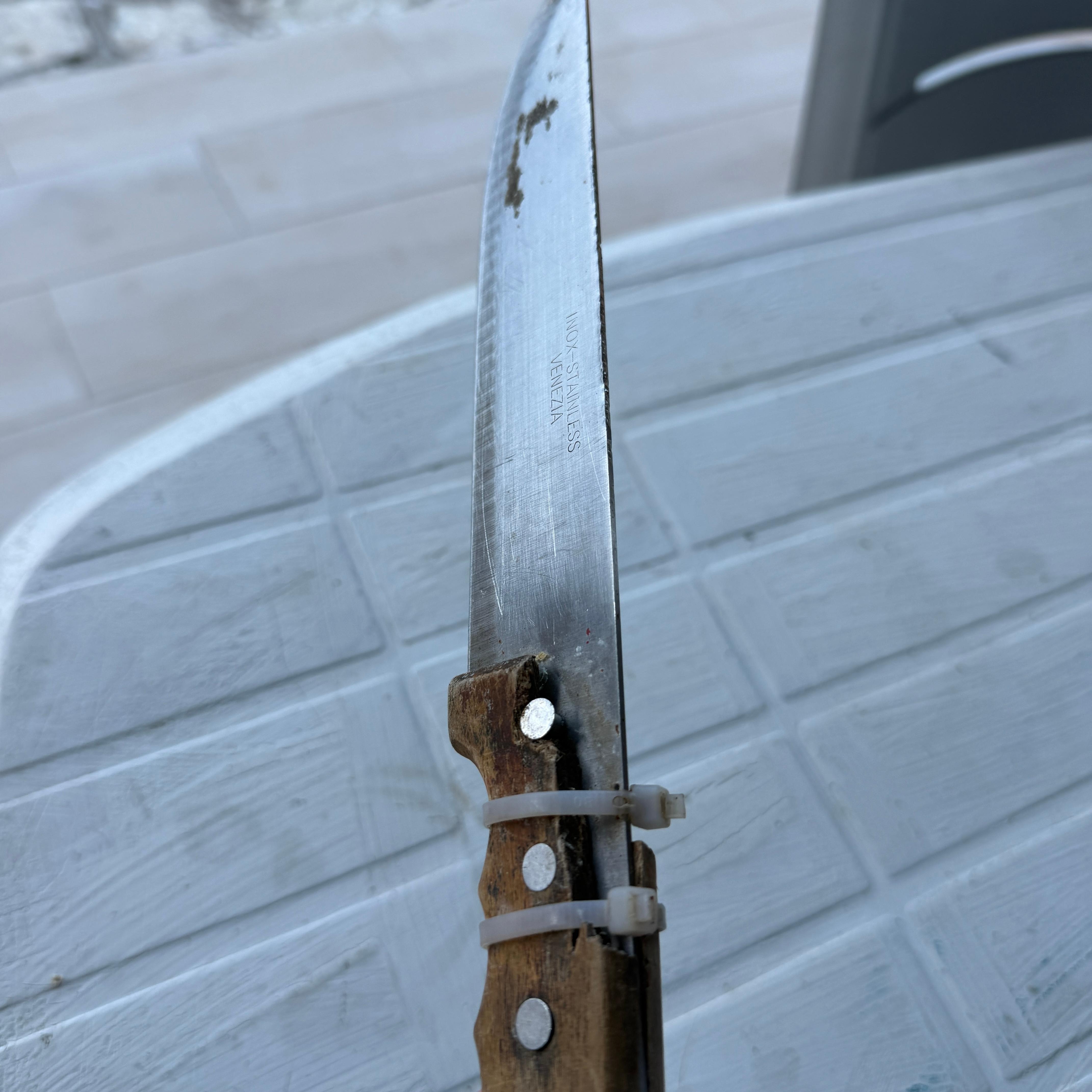 One kitchen knife in a drawer of messy and filthy utensils 