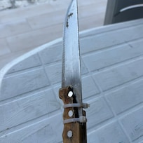 One kitchen knife in a drawer of messy and filthy utensils