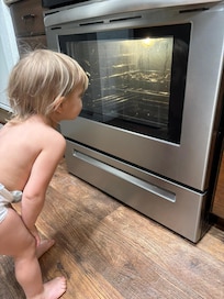 Baby loves the big oven window so she can watch the cookies baking.