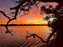 Sunrise across the street over the bay