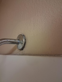 Shower head coming off wall.