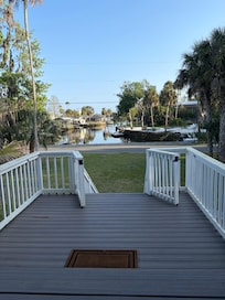 Front porch sitting in rocking chair drinking coffee and looking at the water