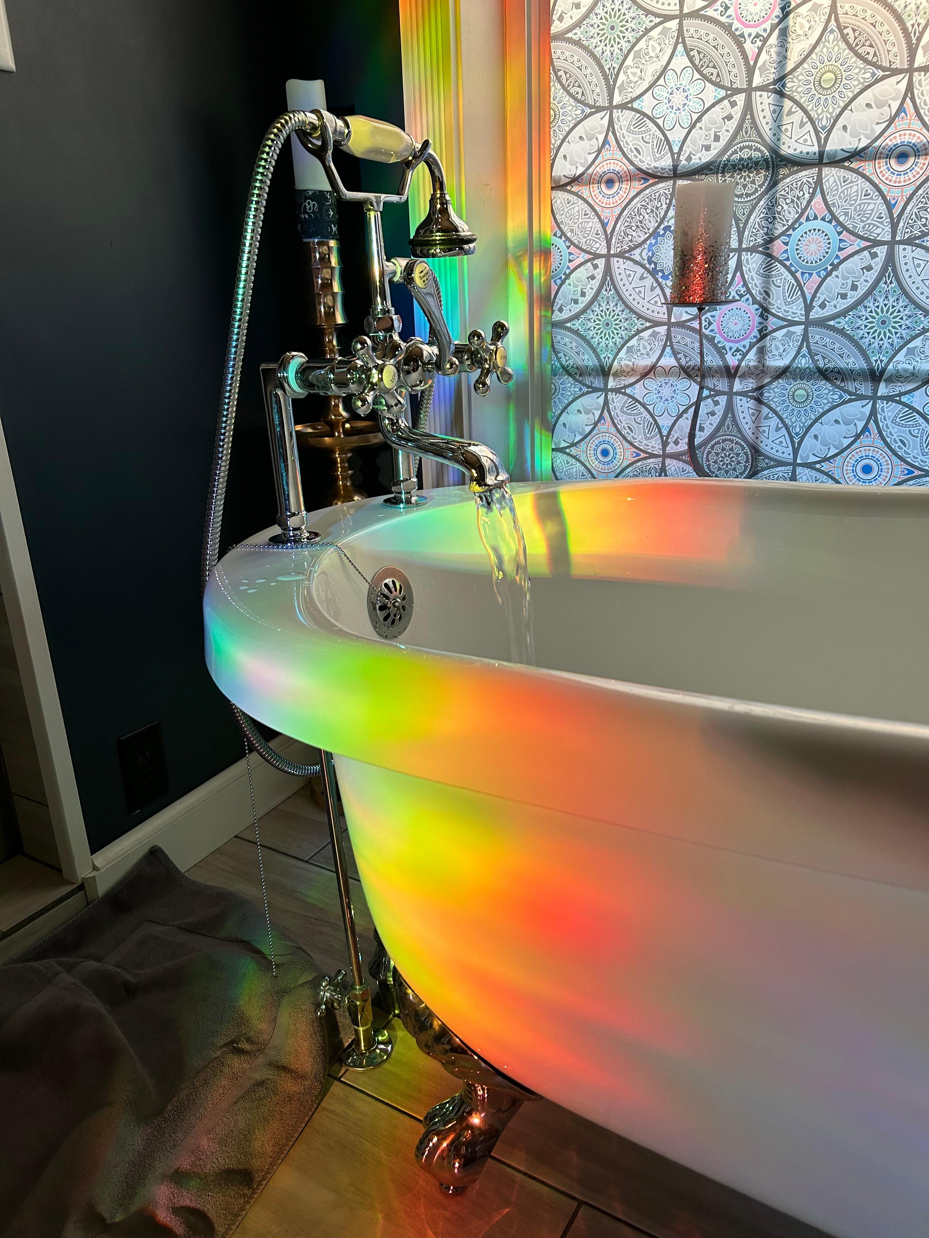 Neat light effect from kitchen window on cozy bathtub 