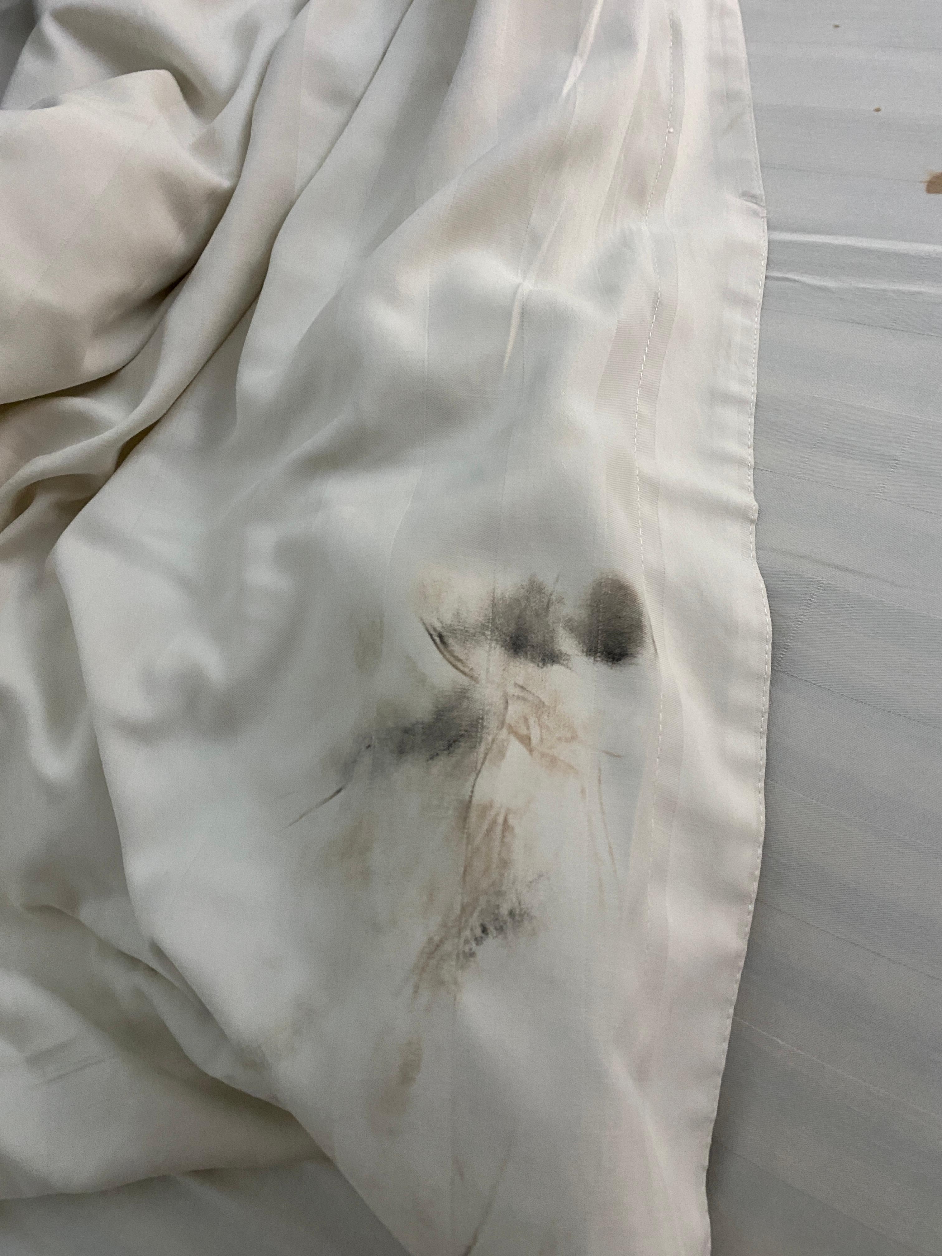 Blood and black stain on sheet