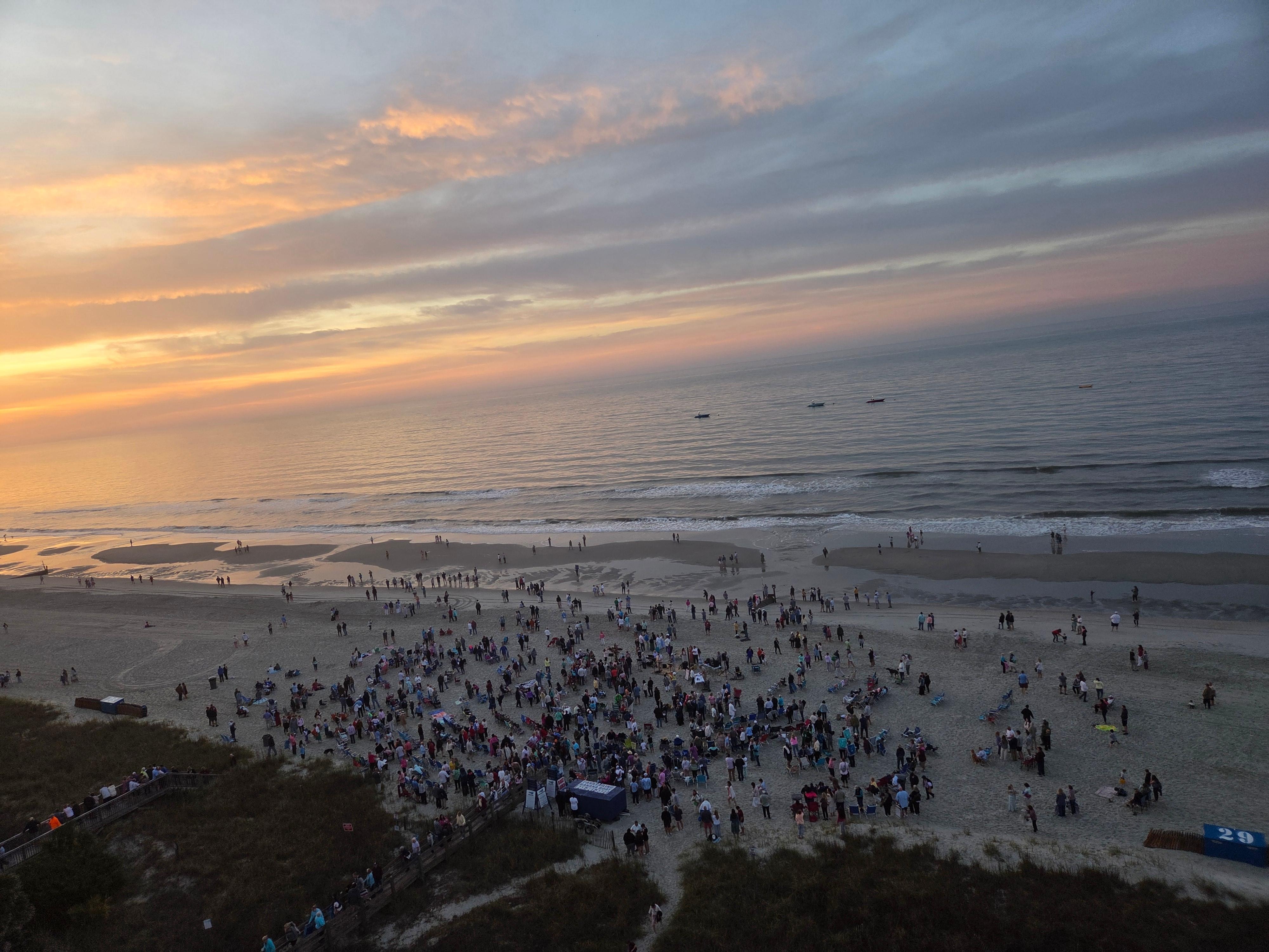 As the sun was rising, the group attending the service were gathering.