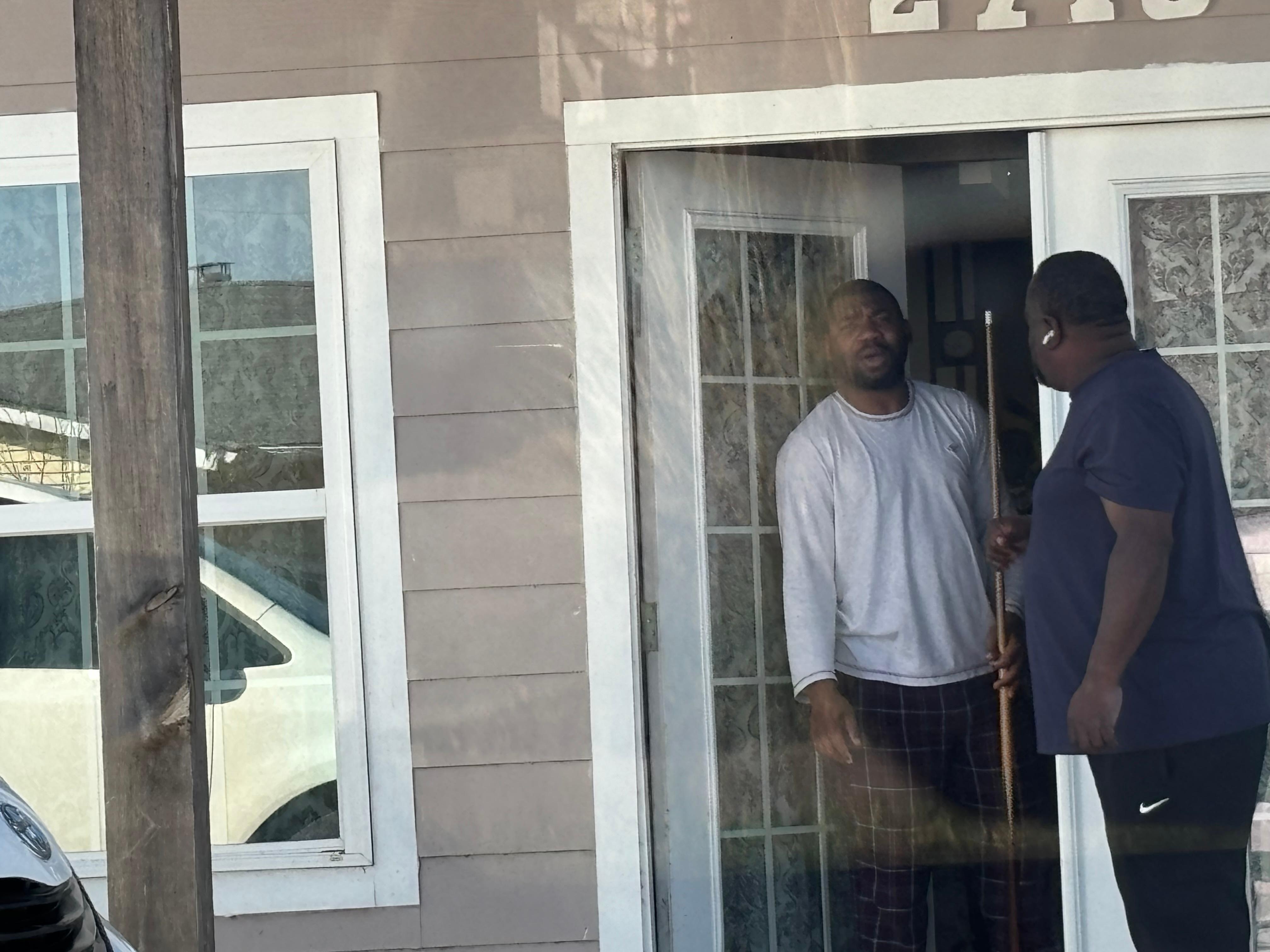 My brother talking to the man who stayed in the house that I rented