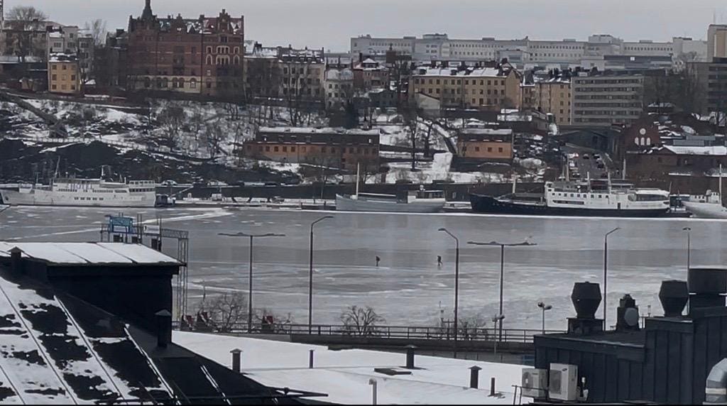 Amazing view of the frozen Archipelago from the hotel room. People enjoy skiing on the frozen lake. 