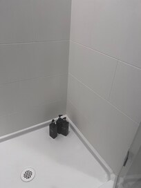 Cleansing products on the shower floor