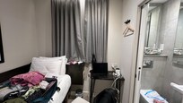 No luggage holder, so you must use the bed. Note proximity of sink to toilet.