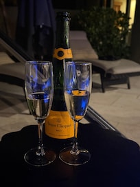 A bottle of champagne, compliments of the hosts, enjoyed by the hot tub under the stars.