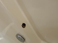 Holes in tub where old jacuzzi jets were removed.