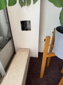 Exposed hole in wall in lounge