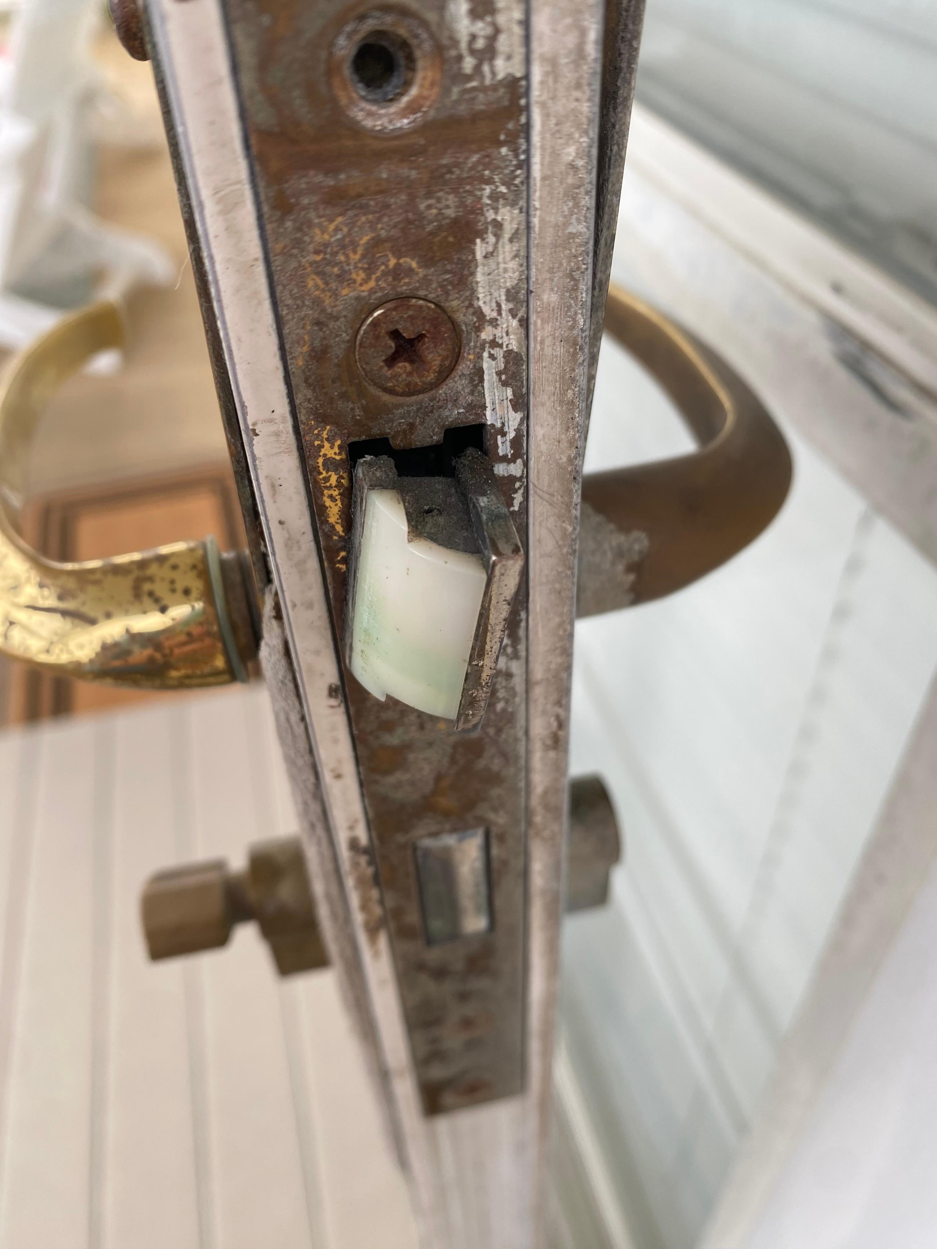 storm door latch was rusted out and unable to latch upon exiting the property.  Main door was locked and chair propped against storm door to secure it