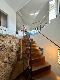 A view upstairs from the landing going down to the master bedroom.