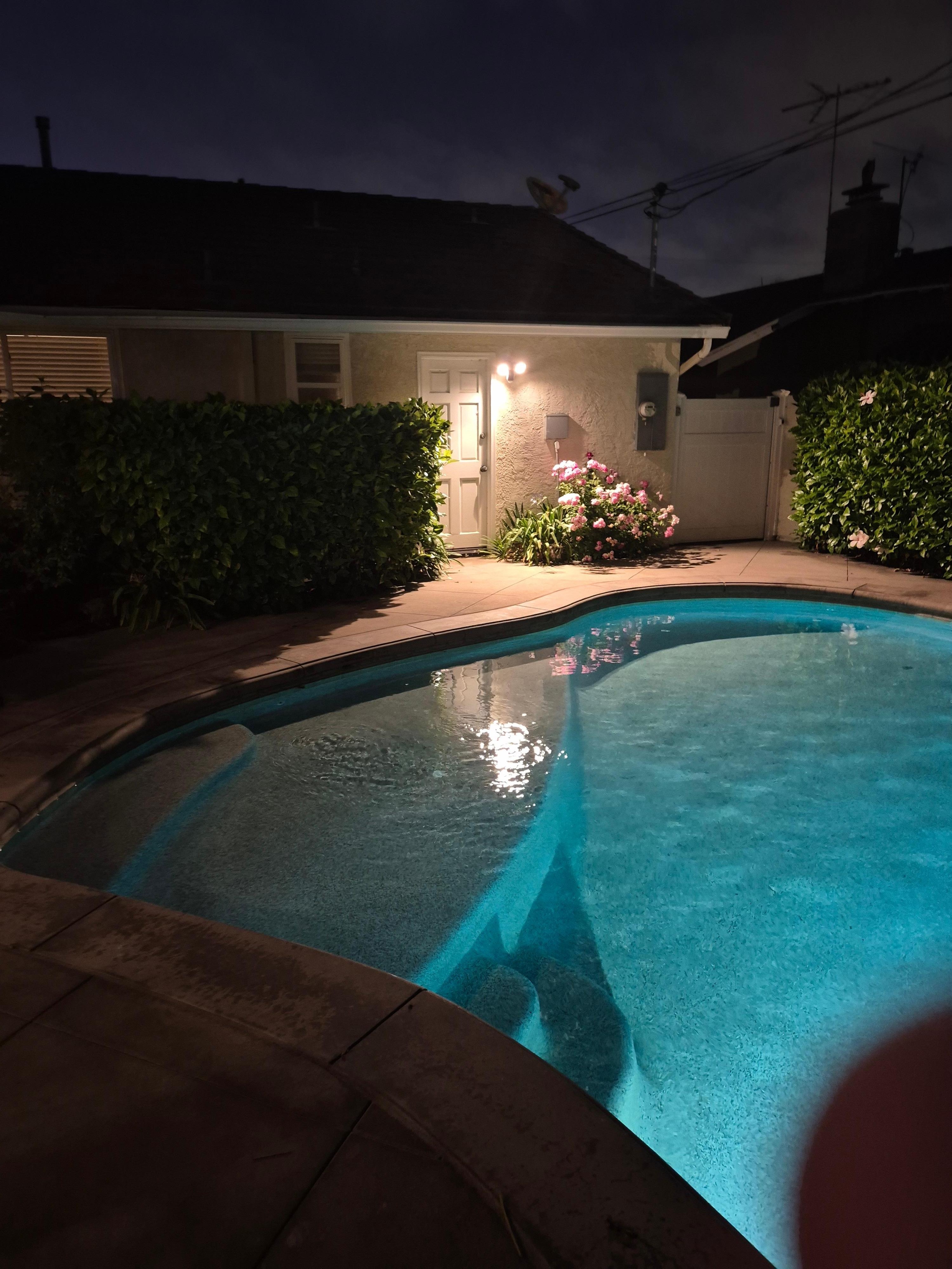 Pool and outside of house at night