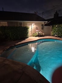 Pool and outside of house at night
