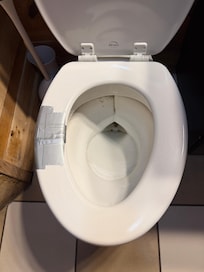 Broken toilet seat we duct taped after it cut buttcheeks!