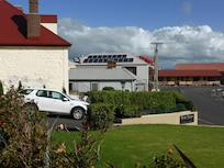 View across the front lawn and car parking at OTT toward the docks end of town