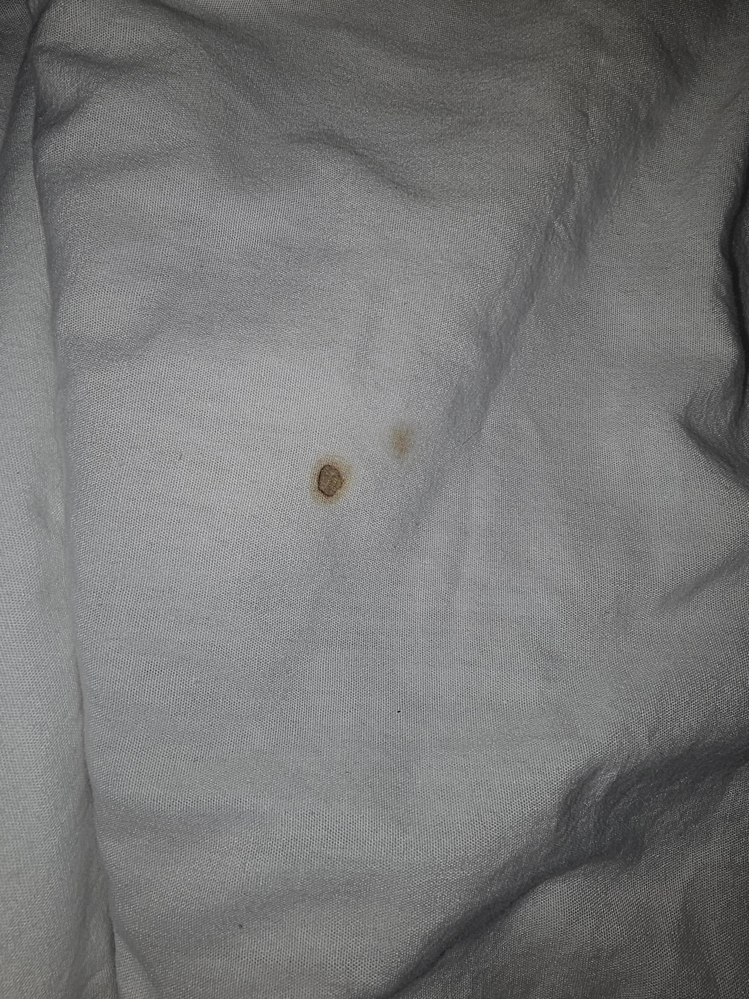 Bedsheets with cigarette burn