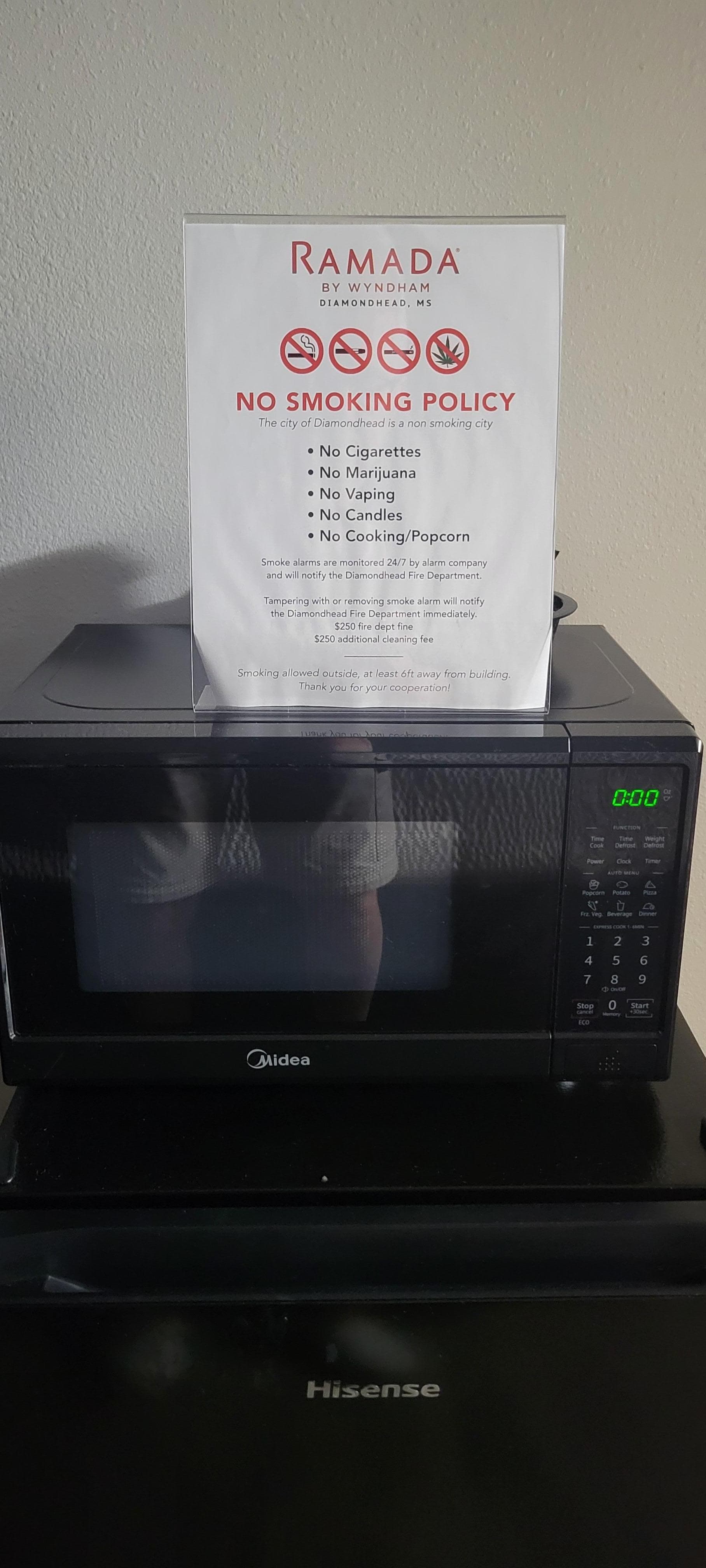 Sign on microwave saying not to use for cooking or popcorn