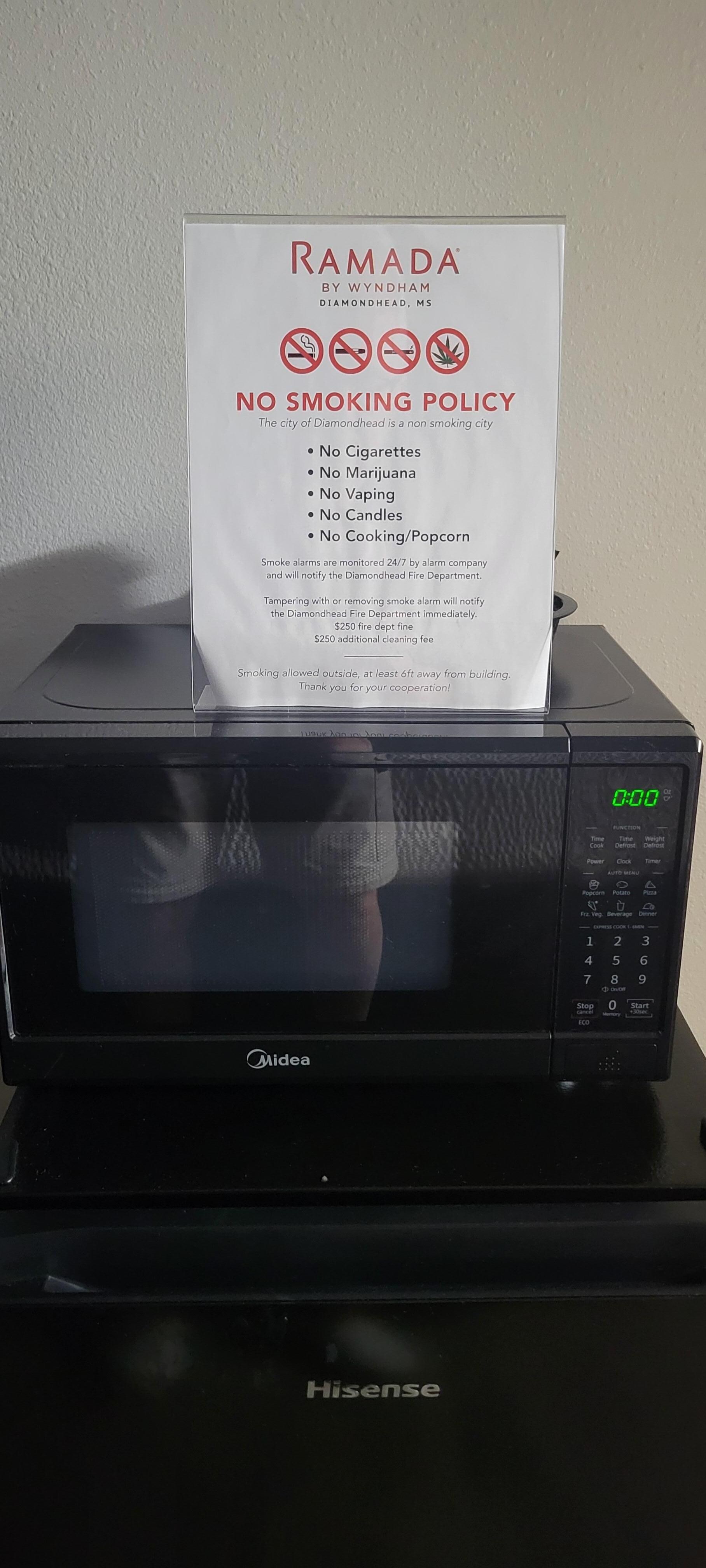 Sign on microwave saying not to use for cooking or popcorn