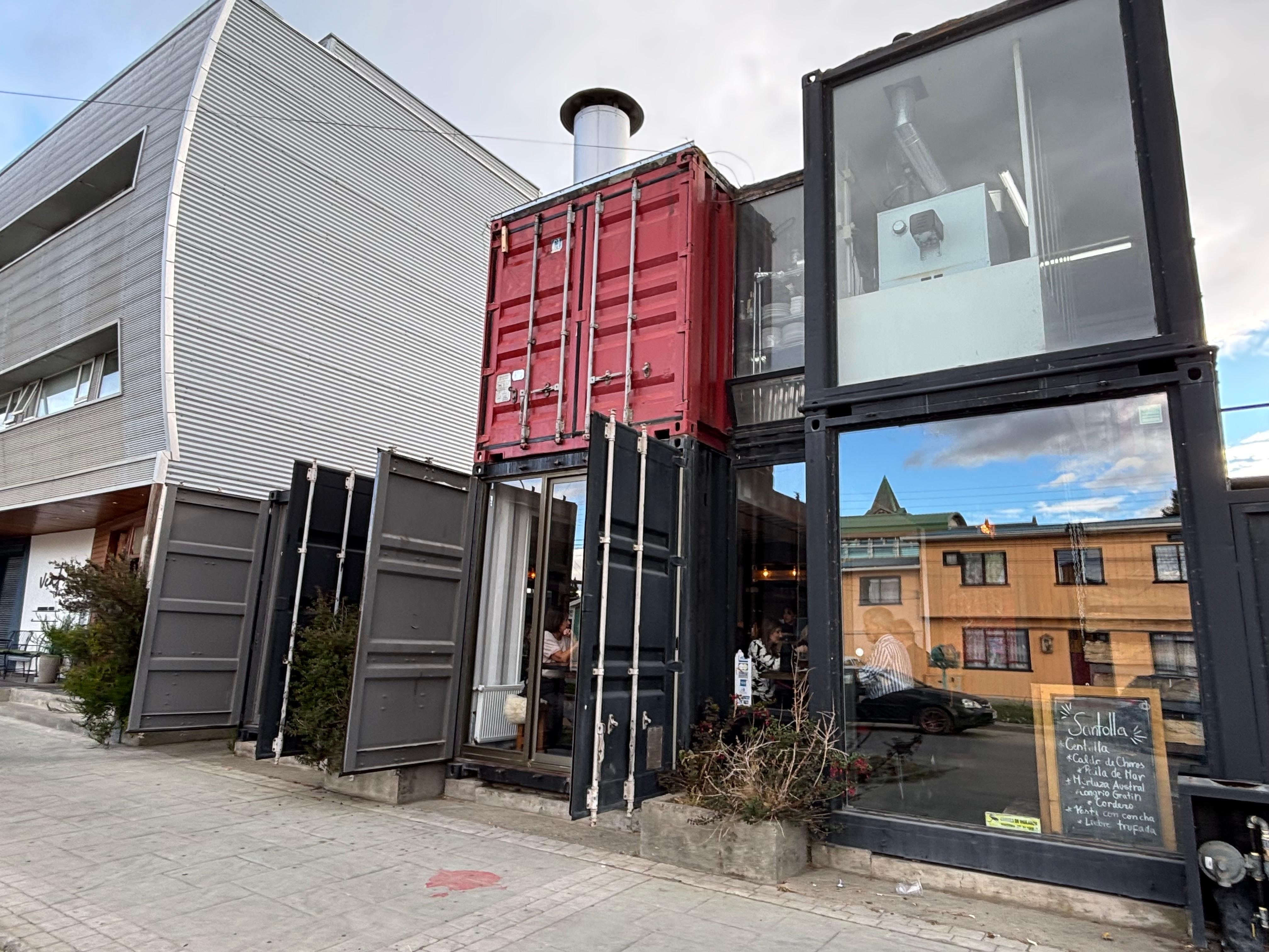 Sliver building to the left of this cool restaurant.