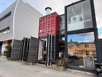 Sliver building to the left of this cool restaurant.