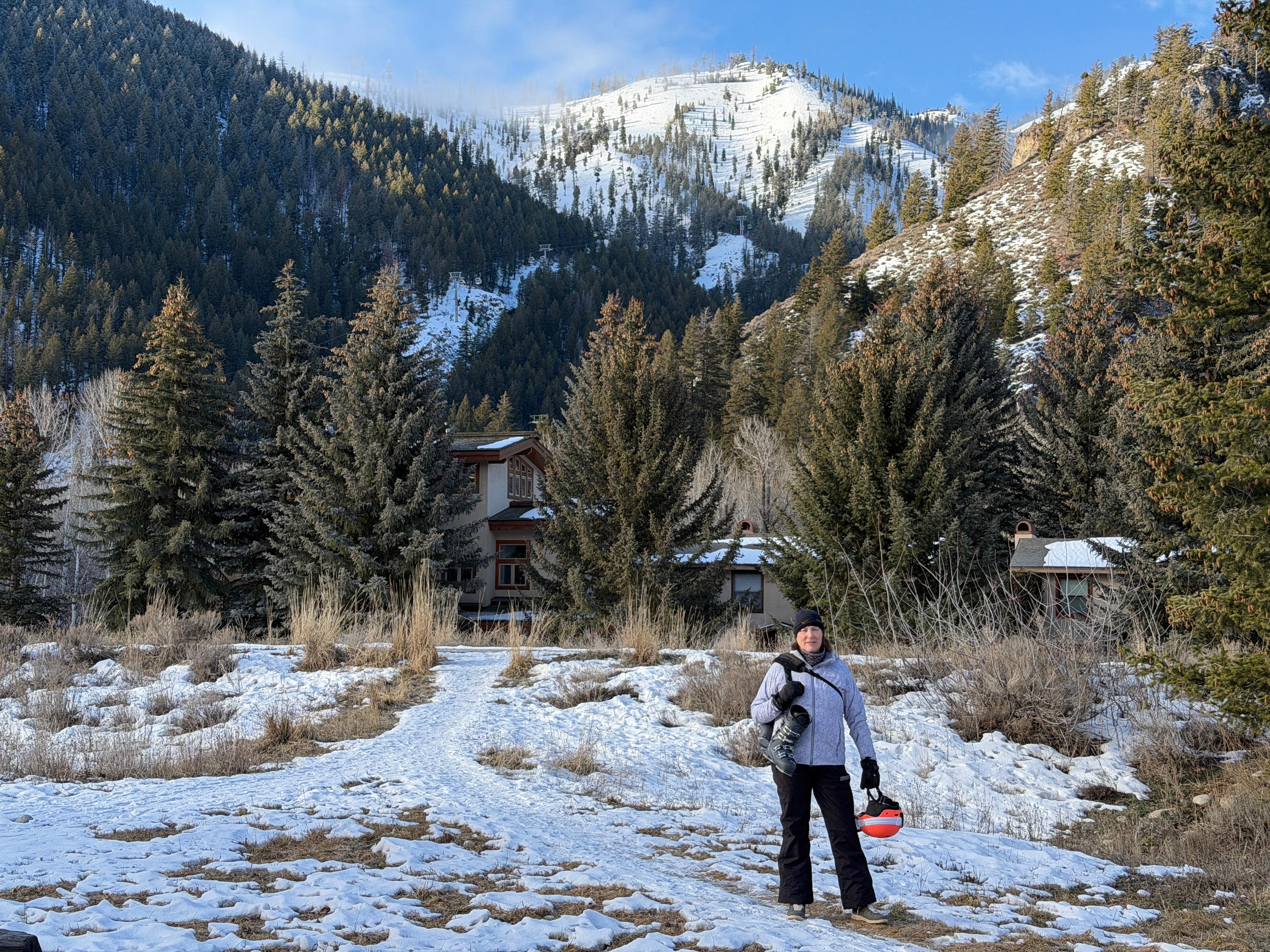 Beth in the parking lot. Look Ma, no skis - they are up there in the locker!