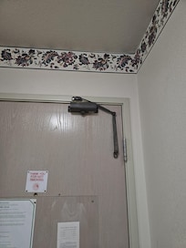 Automatic door closer was hanging loose