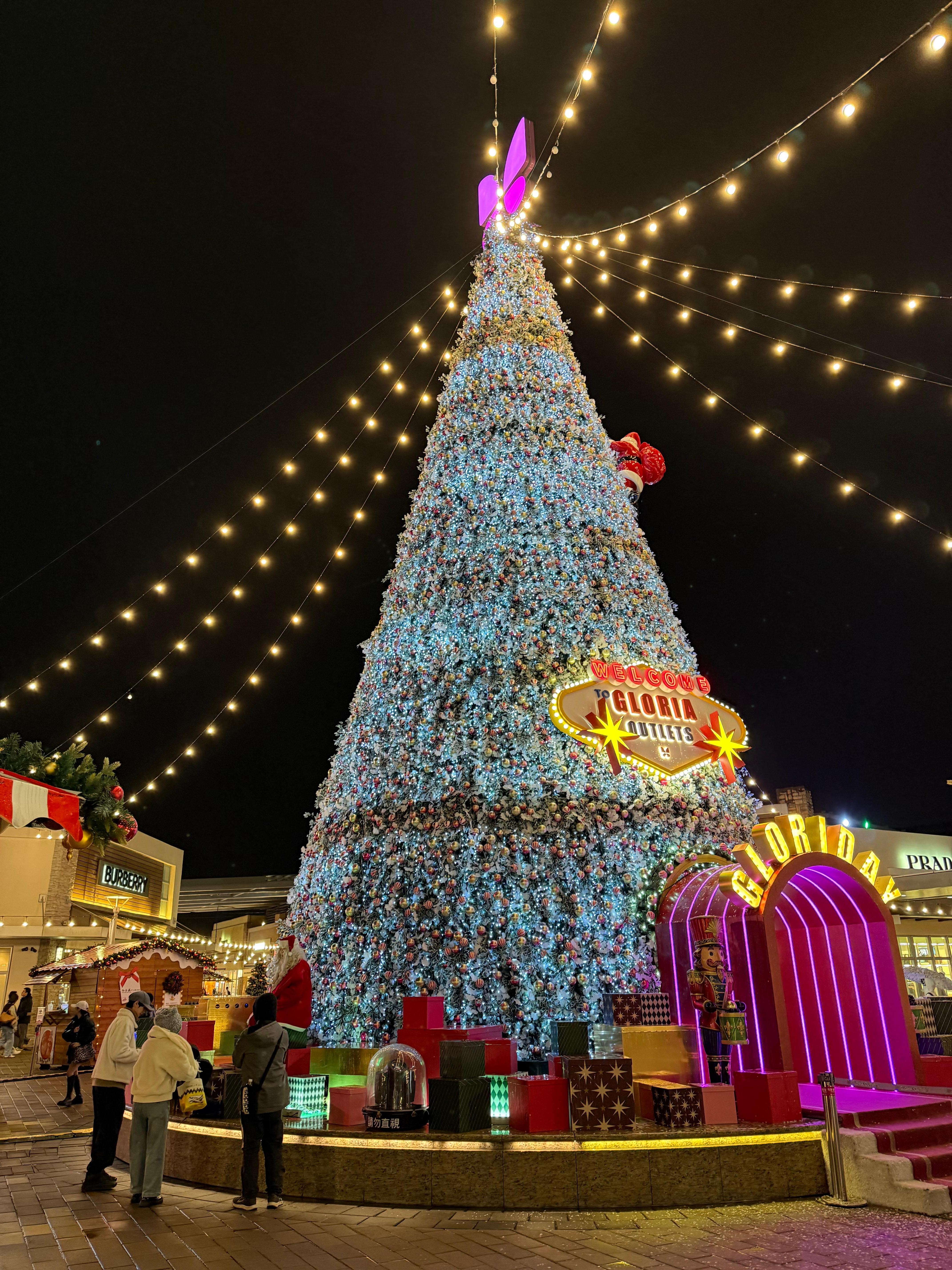 The hotel is next to a large shopping center with a Christmas Tree. 