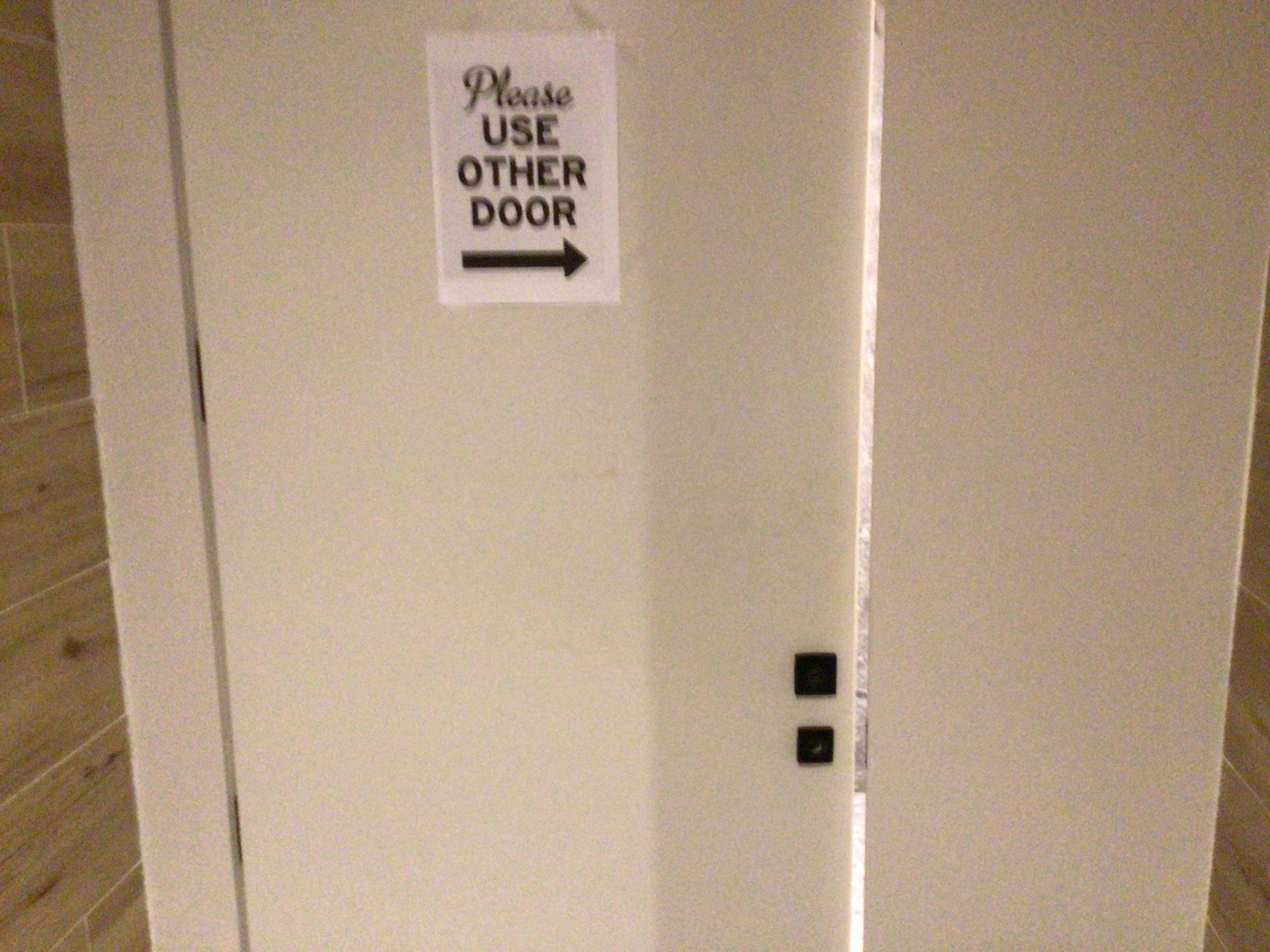 Unisex toilet with broken lock.