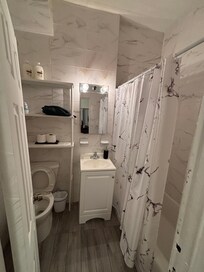 Light fixture with no cover and missing a bulb.