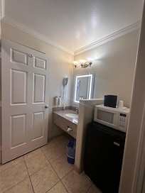Sink area, microwave and mini fridge.