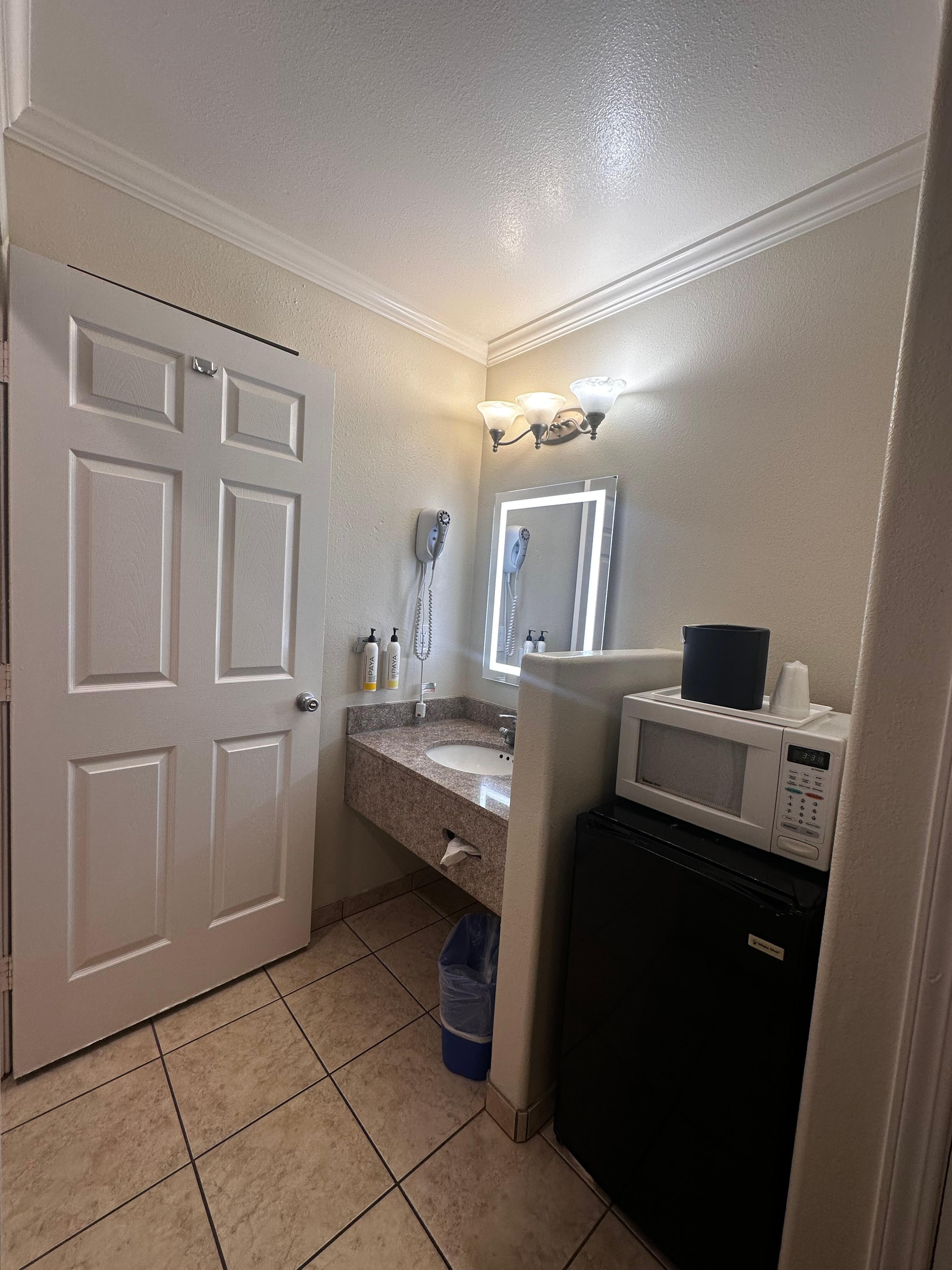Sink area, microwave and mini fridge. 