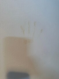 Dirty hand print on the bathroom wall