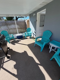 Screened in porch leads to large yard