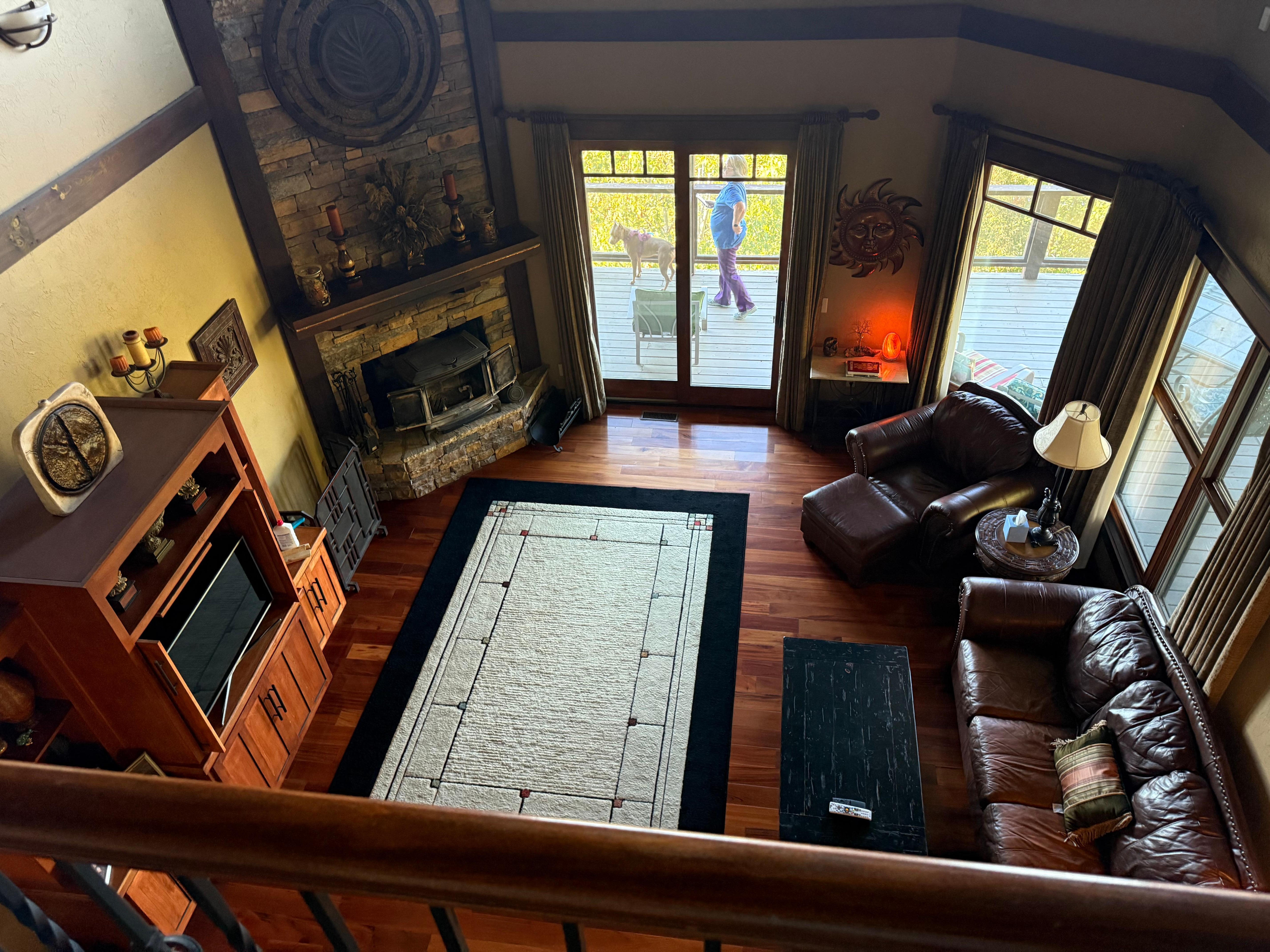 Looking down from the top floor balcony into the main living room