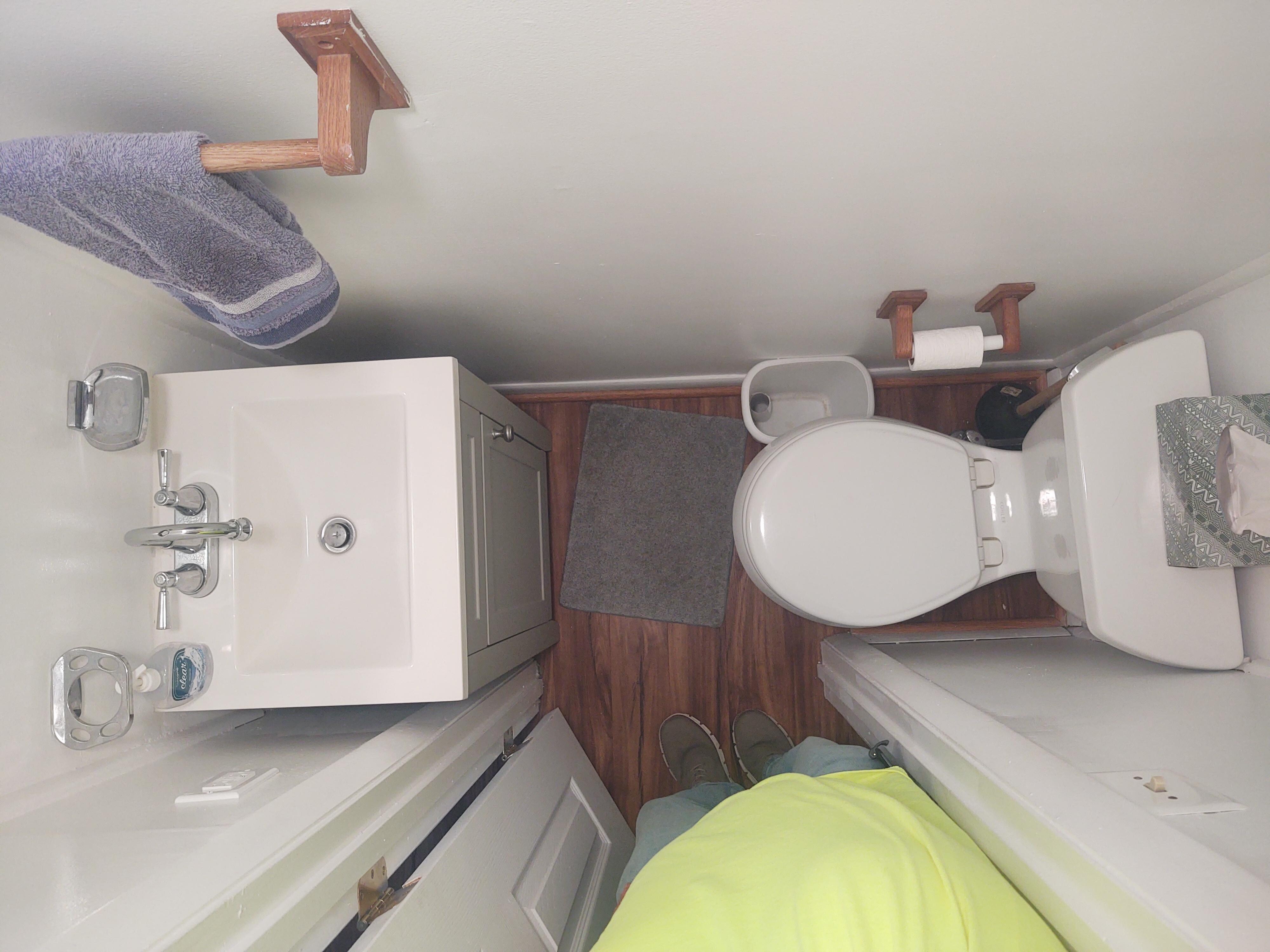 13" approx. From toilet to vanity