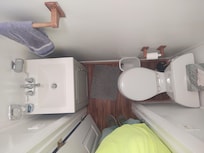 13" approx. From toilet to vanity