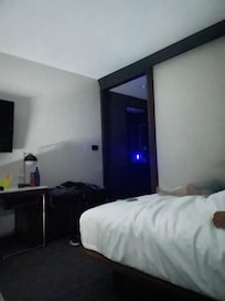 Bright blue light on a mirror stays on all night, no way to turn off or unplug it, making it hard to sleep.