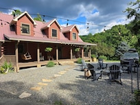 The beautiful front porch of the house and the stone pathway to an additional covered outdoor area