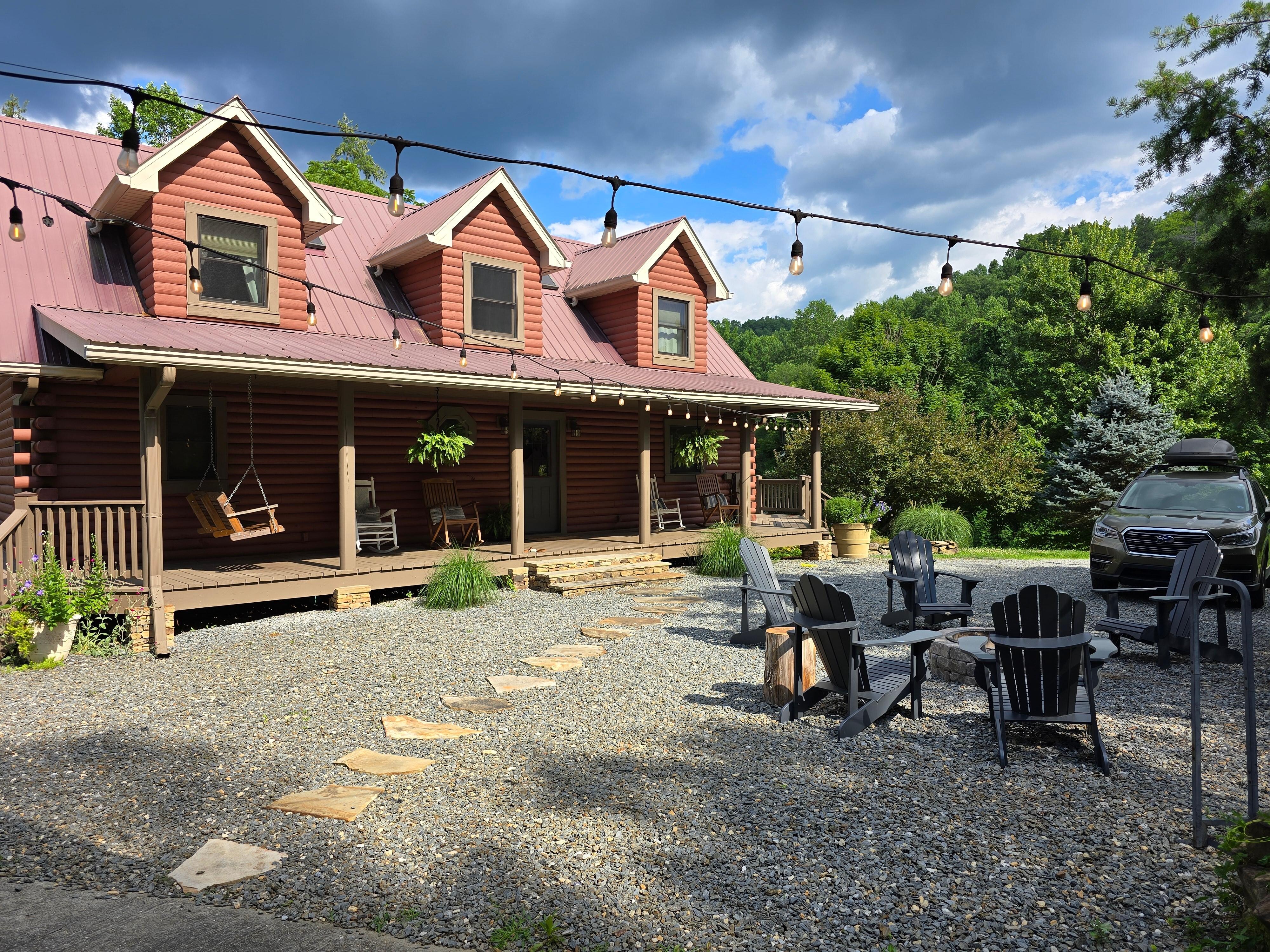 The beautiful front porch of the house and the stone pathway to an additional covered outdoor area