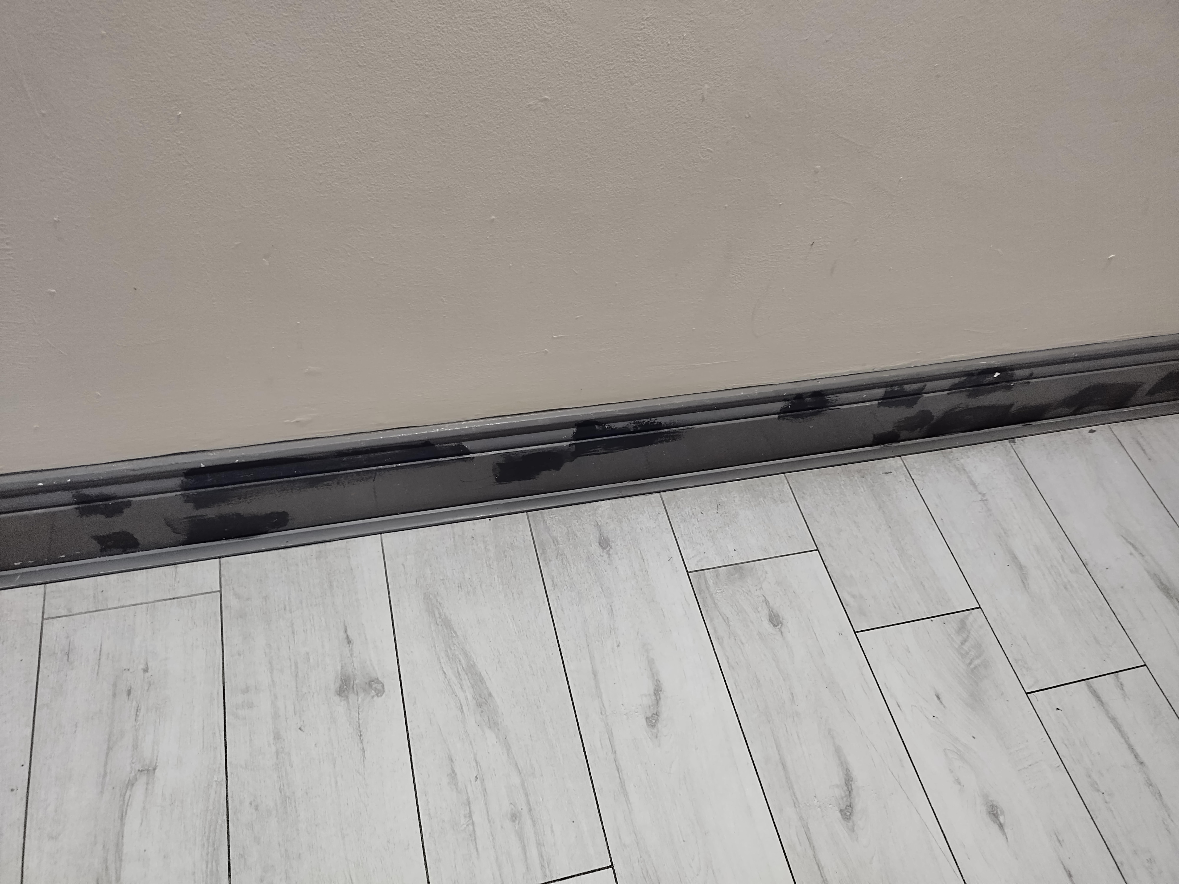 Black patches over skirting board