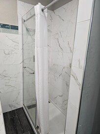 Fix glass shower door and shower curtain hung to replace sliding glass door.